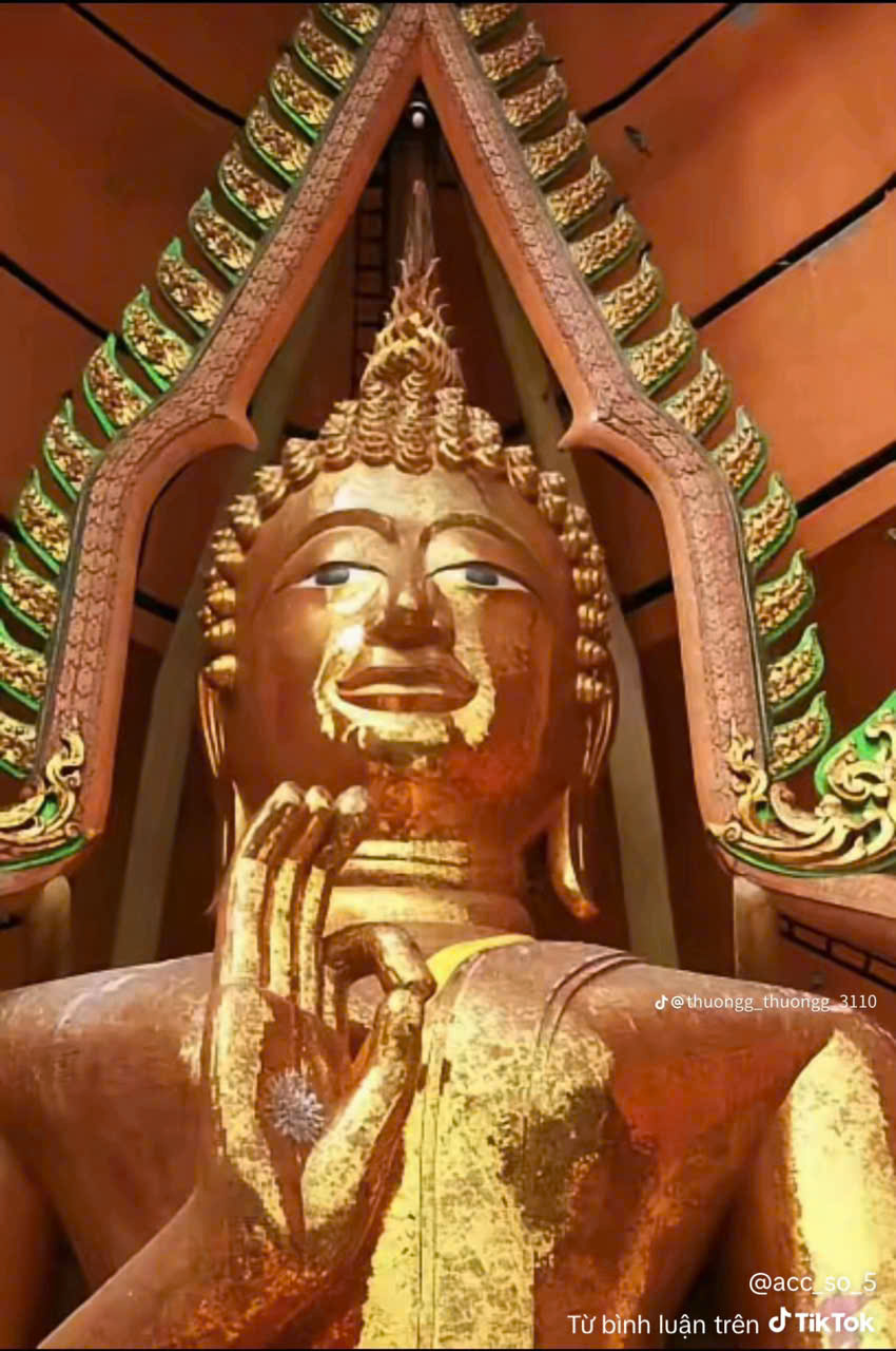 Portrait of a smiling elderly woman with short white hair.